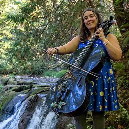 Erin Esses Lusk playing a fiberglass Cello in the woods
