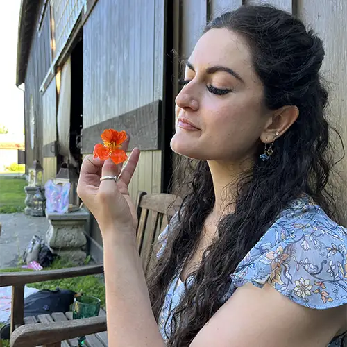 Kera Newman holding a pink flower